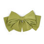 Green satin hair clip in the shape of a maxi bow.